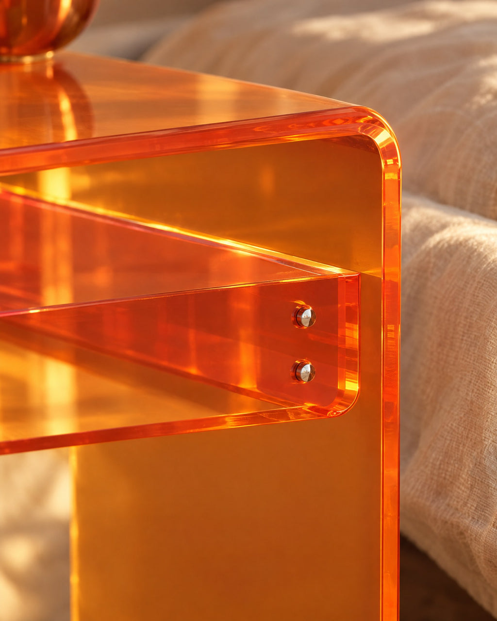 Close-up of the rounded amber acrylic corner and the bolted shelf strip
