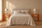 Pair of amber acrylic bedside tables on each side of a double bed