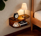 Amber acrylic floating bedside shelf in a bedroom