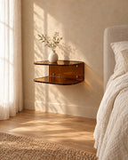 Three-quarter view of the amber acrylic floating bedside shelf fixed to the wall above a clear floor