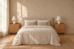 Pair of bamboo bedside tables with three drawers on each side of a double bed