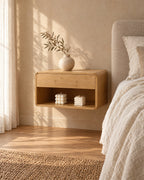 Three-quarter view of the bamboo floating bedside table fixed to the wall above a clear floor