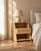 Bamboo and rattan bedside table with a ceramic lamp in morning light