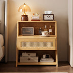 Bamboo and rattan bedside table with a drawer and open shelves beside a bed