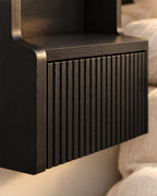 Close-up detail of the black floating bedside table