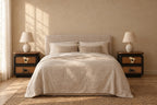 Pair of black rattan bedside tables on each side of a double bed