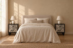 Pair of black bedside tables with floral toile drawers on each side of a double bed
