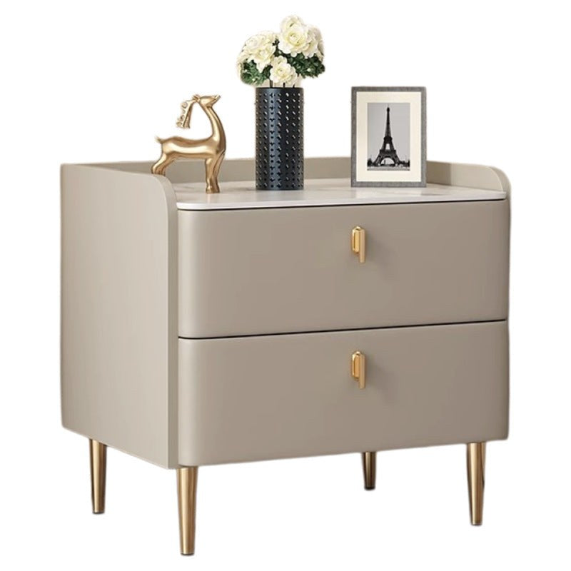 Front view of the champagne grey bedside table with two drawers and gold legs