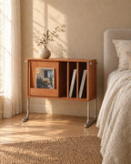 Three-quarter view of the cherry wood cabinet showing the chrome tube legs