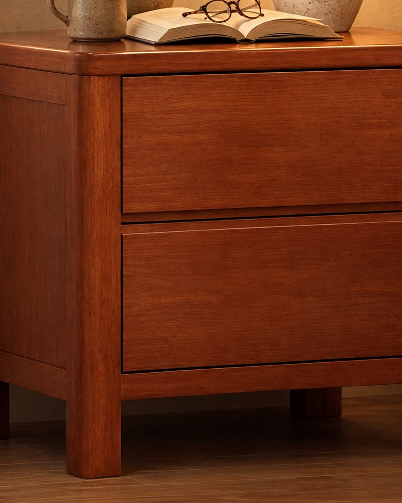 Close-up of the cherry wood grain and the plain drawer fronts