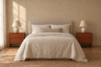Pair of cherry-tone wooden bedside tables with two handle-free drawers either side of a double bed