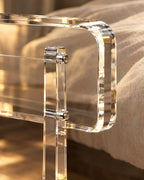 Close-up of a clear acrylic leg bolted to the rounded frame