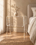Three-quarter view of the clear acrylic bedside table