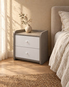 Three-quarter view of the grey and white bedside table showing the curved side panels