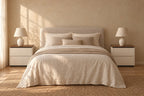 Pair of cream bedside tables with walnut-tone tops on each side of a double bed