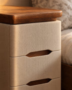 Close-up of the oval walnut-tone finger pull and the overhanging top
