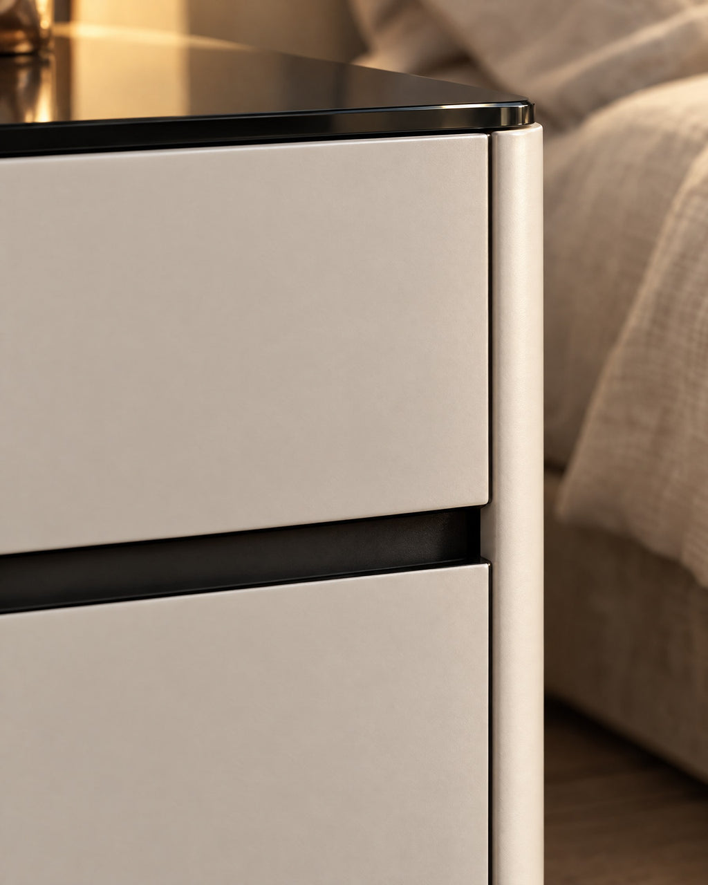 Close-up detail of the cream bedside table with a glossy black top and two drawers