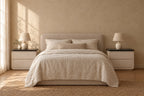 Pair of cream bedside tables with black tops on each side of a double bed