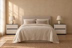 Two cream bedside tables with a glossy black top and two drawers on each side of a double bed
