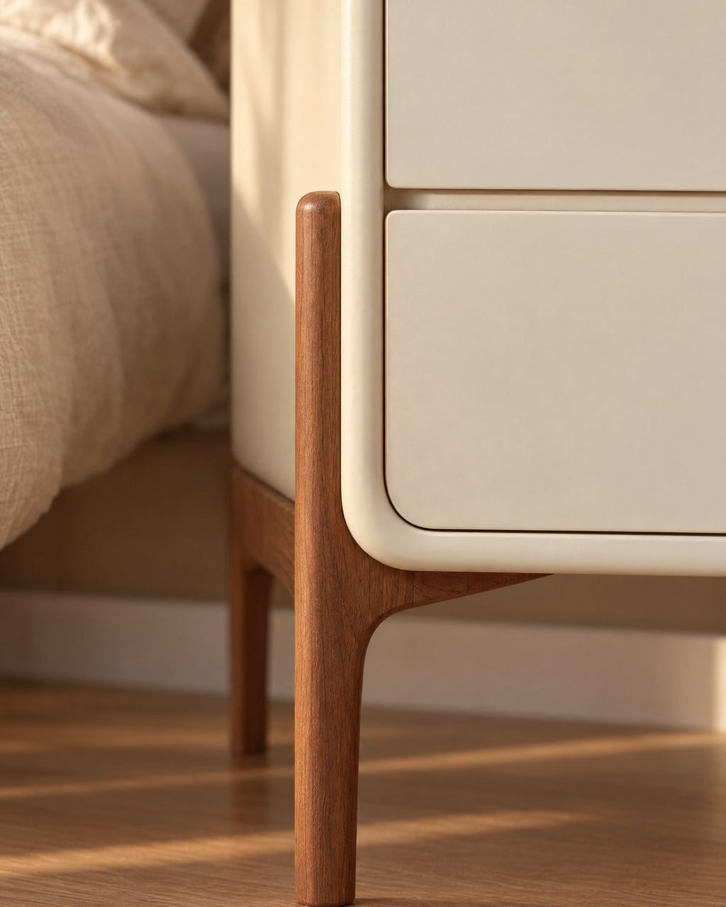 Close-up of the walnut-tone leg rising up the side of the cream body