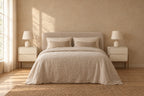 Pair of cream bedside table on walnut-tone legss on each side of a double bed