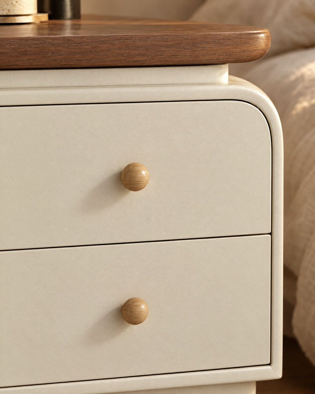 Close-up of the round wooden knob and the walnut-tone top edge