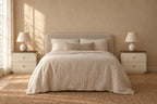 Pair of cream bedside table with walnut-tone top and wooden knobss on each side of a double bed