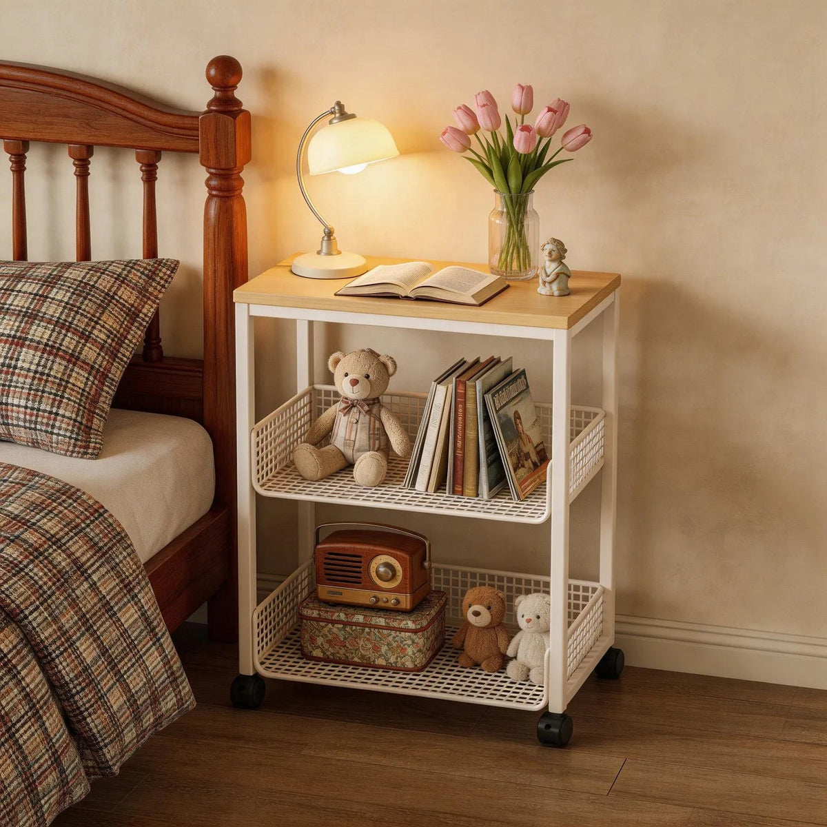 Cream bedside trolley with two mesh baskets beside a wooden bed