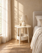 Cream flower-shaped bedside table with a storage basket with a ceramic lamp in warm morning light