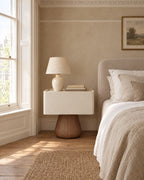 Cream Bedside Table beside a linen bed in a bright British bedroom with a sash window