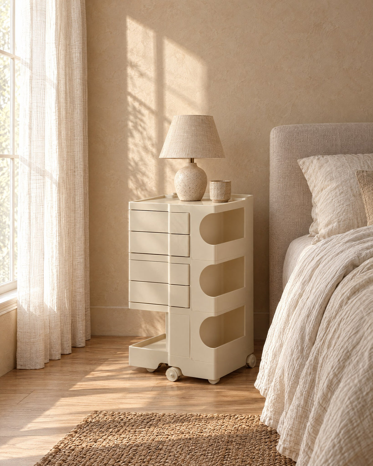 Cream bedside trolley with rounded open compartments in morning light