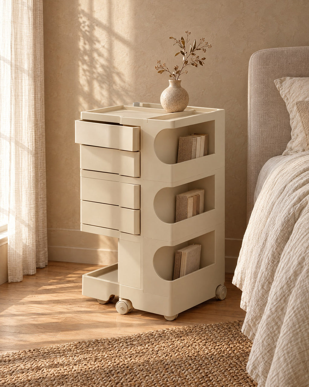 Three-quarter view of the cream trolley with a swivel drawer open and books in the side compartments