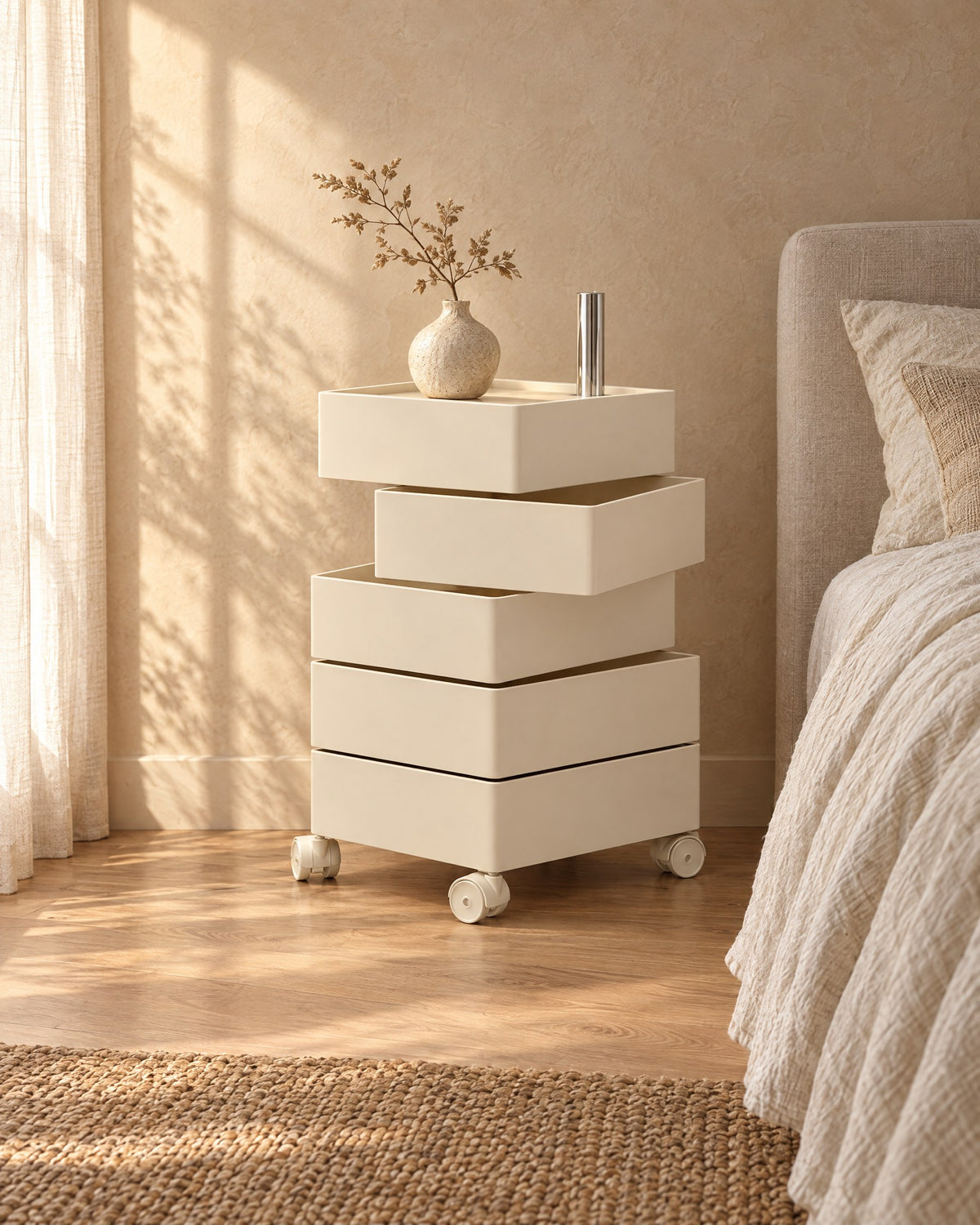 Cream bedside storage unit with two trays swivelled open, on castors