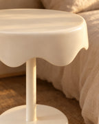 Close-up of the wavy draped edge of the round cream top