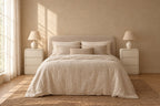 Pair of cream rounded three-drawer bedside tables on each side of a double bed