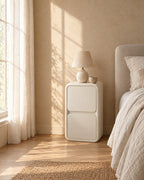 Cream bedside table with rounded edges in morning light