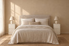 Pair of cream rounded bedside tables on each side of a double bed