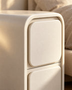 Close-up of the large rounded corner of the cream frame and drawer edge