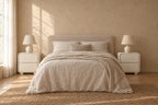 Pair of cream rounded-frame bedside tables on each side of a double bed