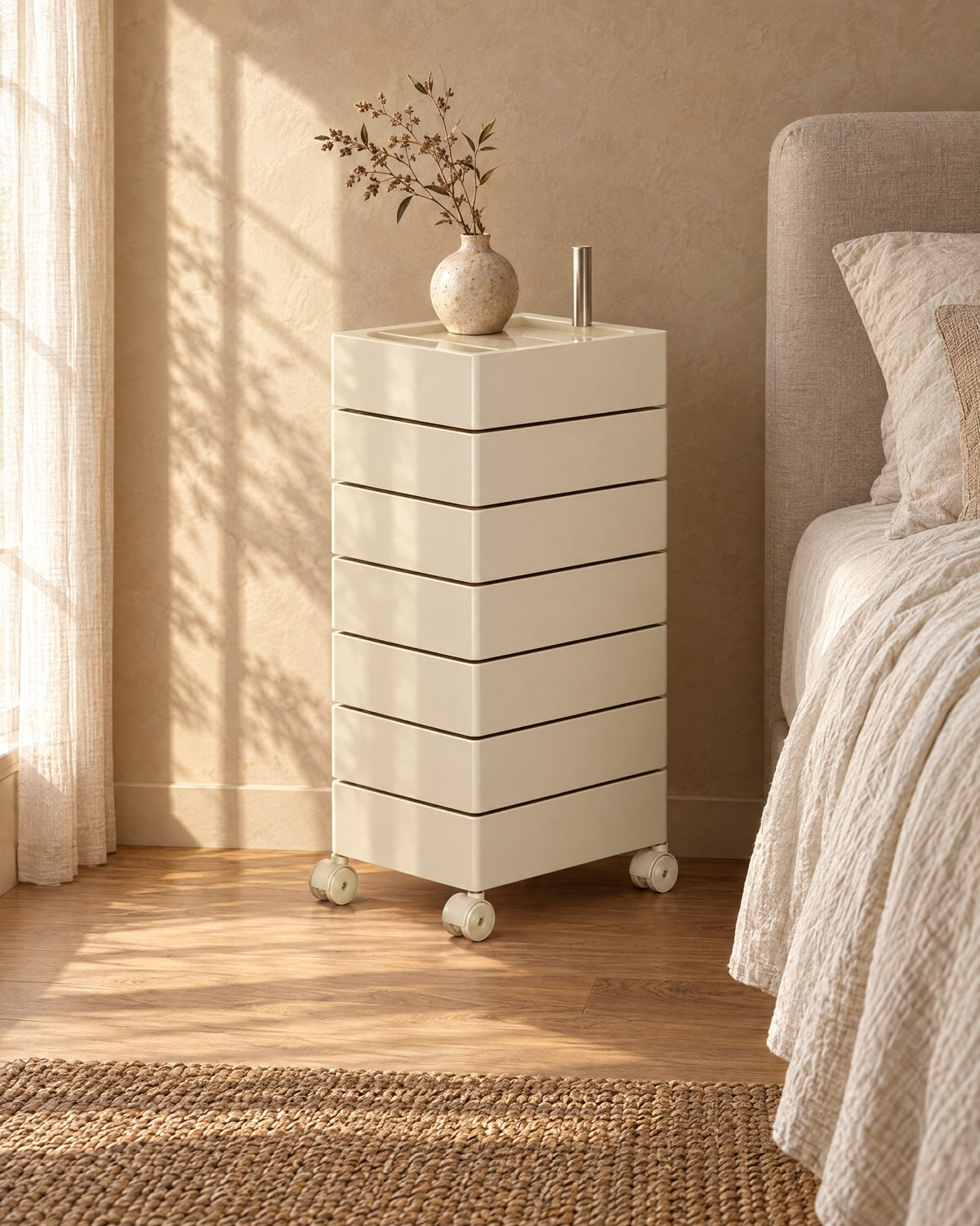 Three-quarter view of the cream drawer tower showing its castors and steel pivot