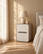 Cream and taupe rounded bedside table in warm morning light
