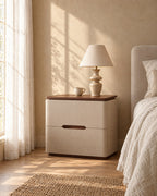 Cream bedside table with a walnut top in morning light