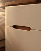 Close-up of the inset walnut finger pull and the cream faux-leather