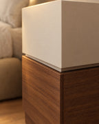 Close-up of the hidden grip between the cream and walnut drawers