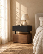 Two-tone floating bedside table with a ceramic lamp in morning light
