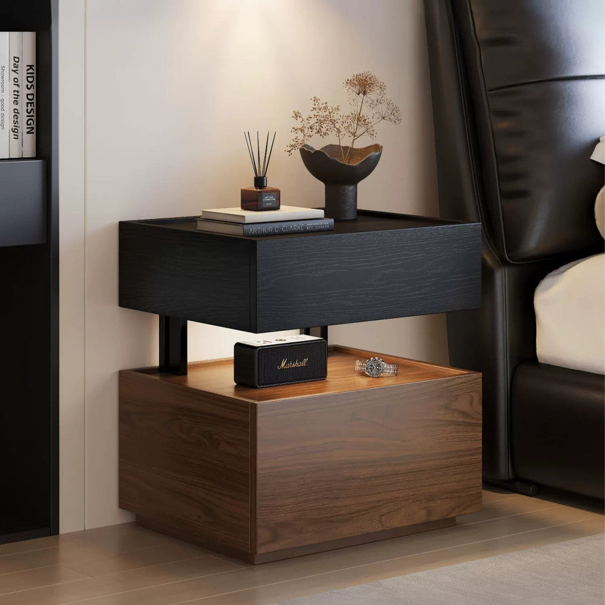 Black and walnut floating bedside table beside a bed