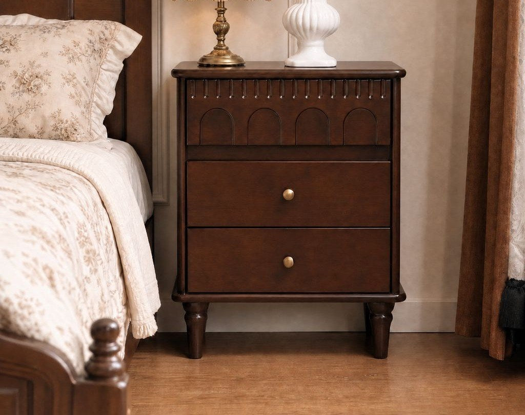 French-style dark walnut bedside table beside a classic bed