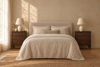 Pair of French-style walnut bedside tables either side of a double bed