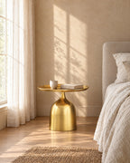 Gold metal round bedside table in warm morning light