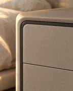 Close-up of the rounded greige frame and its charcoal edge line